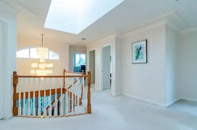 a hallway with a staircase in a home with a chandelier at 3 Private, spacious, bright rooms in a Gorgeous house in New Westminster