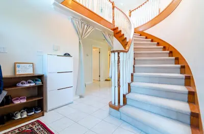 a staircase in a living room with a stair case at 3 Private, spacious, bright rooms in a Gorgeous house in New Westminster
