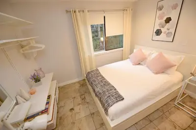 a small bedroom with a bed and a window at Newly Renovated Whistler Studio in Whistler
