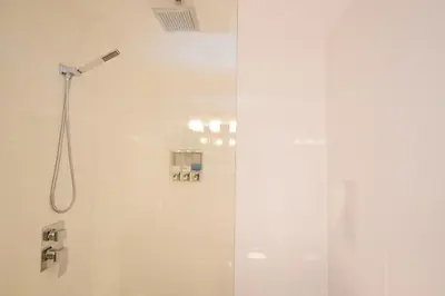a bathroom with a shower with a glass door at Newly Renovated Whistler Studio in Whistler