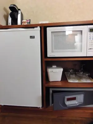 a white microwave sitting next to a microwave oven at Rosslyn Inn & Suites in Edmonton