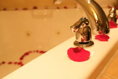 a bathroom sink with a little figurine in a faucet at Rosslyn Inn & Suites in Edmonton