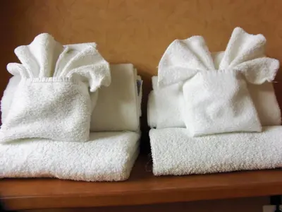 two towels sitting on top of a wooden shelf at Rosslyn Inn & Suites in Edmonton