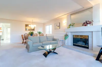 a living room with a couch and a fireplace at Great Guest Suite in a Gorgeous House in New Westminster