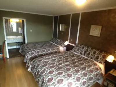 a hotel room with two beds and a couch at Galaxy Motel in St. Paul
