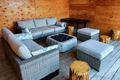 a living room with a couch and chairs and a table at Red Cariboo Apartments in Anahim Lake