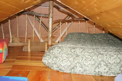 a bed in a room with a wooden floor at The Magical Dome in Lund