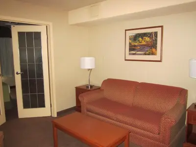 a living room with a couch and a table at Super 8 by Wyndham Fort St. John BC in Fort Saint John