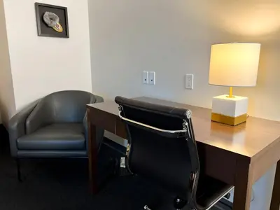 an office with a desk and a chair and a lamp at Edgewater Hotel in Whitehorse