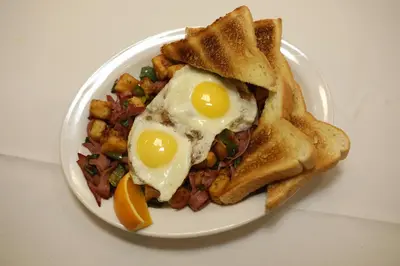 a plate of breakfast food with eggs and toast at Continental Inn & Suites in Edmonton