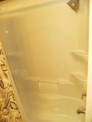 a white bath tub with shelves in a bathroom at Parkside Inn in Haines Junction