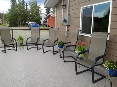 a group of chairs sitting on a porch at Parkside Inn in Haines Junction