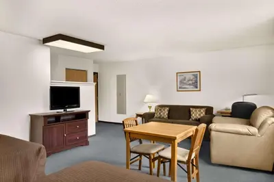 a living room with a couch a table and a tv at Super 8 by Wyndham Williams Lake BC in Williams Lake
