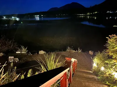 a view of a body of water at night at Oceanfront Room With Hot Tub & Firepit in Ucluelet
