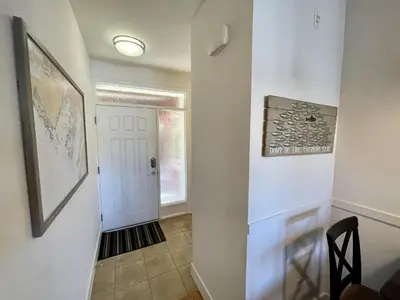 a hallway of a home with a white door at Marina View On The Harbour in Ucluelet