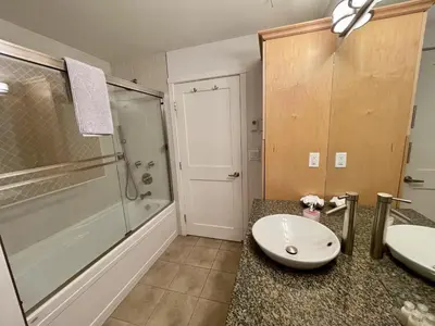 a bathroom with a sink and a shower at Marina View On The Harbour in Ucluelet