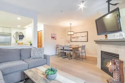 a living room with a couch and a fireplace at Sunpath by Outpost Whistler in Whistler