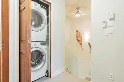 a laundry room with a washer and dryer at Sunpath by Outpost Whistler in Whistler