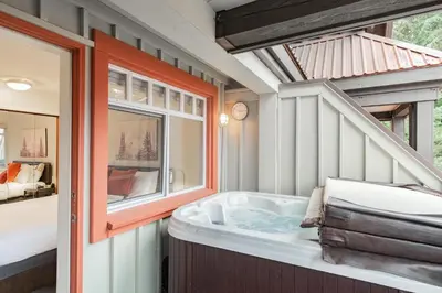 a bathroom with a tub and a window at Sunpath by Outpost Whistler in Whistler