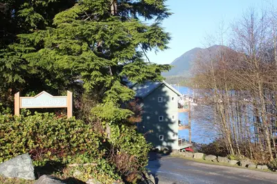 a sign for a hotel on the side of a road at Siennas Harbour House in Tofino
