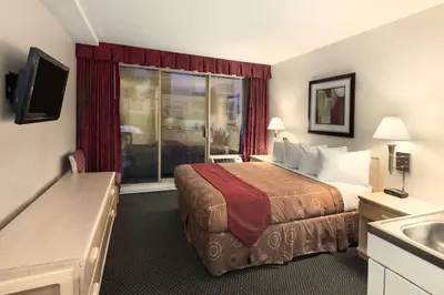 a hotel room with a bed and a window at Travelodge by Wyndham Nanaimo in Nanaimo