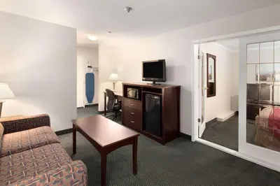 a hotel room with a couch and a tv at Travelodge by Wyndham Nanaimo in Nanaimo