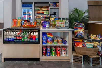 a refrigerator filled with lots of drinks in a store at Hilton Garden Inn Calgary Airport in Calgary