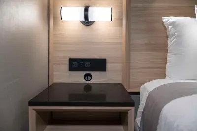 a bedroom with a bed and a clock on the wall at Accent Inns Kelowna in Kelowna