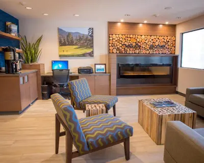 a living room with a couch and a fireplace at Accent Inns Kelowna in Kelowna