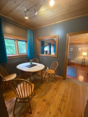 a dining room with a table and chairs at Historic Hotel Bayview in Stewart