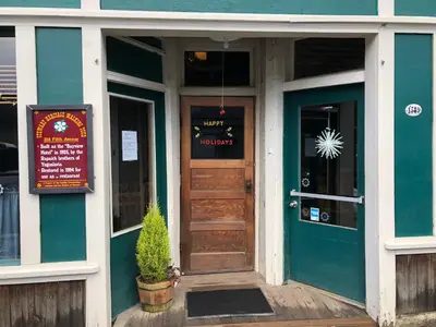 a front door of a restaurant with a sign on the door at Historic Hotel Bayview in Stewart