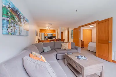 a living room with a couch and a coffee table at Glaciers Lodge by Outpost Whistler in Whistler
