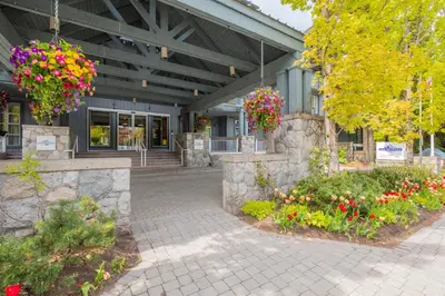 a building with flowers in front of it at Glaciers Lodge by Outpost Whistler in Whistler