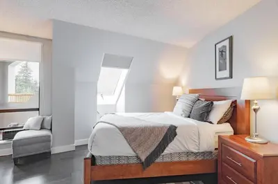 a bedroom with a bed and a chair in it at Marquise by Outpost Whistler in Whistler