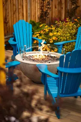 a group of blue chairs sitting around a fire pit at Hotel Zed Victoria in Victoria