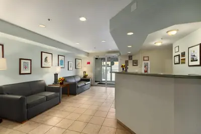 a lobby of a hospital with couches and a bar at Super 8 by Wyndham Yellowknife in Yellowknife