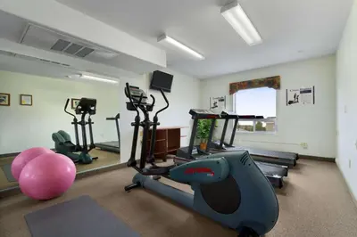 a gym with exercise bikes and a exercise ball at Super 8 by Wyndham Yellowknife in Yellowknife