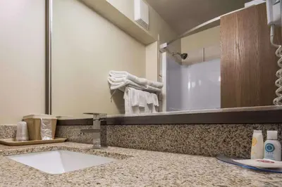 a bathroom with a sink and a mirror at Comfort Inn & Suites in Langley
