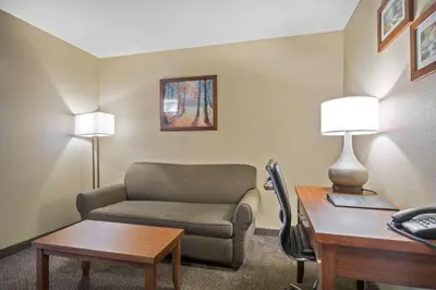a room with a couch and a desk and a chair at Comfort Inn & Suites in Langley