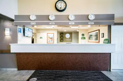 a waiting room with a clock on the wall at Comfort Inn & Suites in Langley