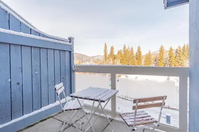 a porch with a bench and a table and chairs at Tyndall Stone by Outpost Whistler in Whistler
