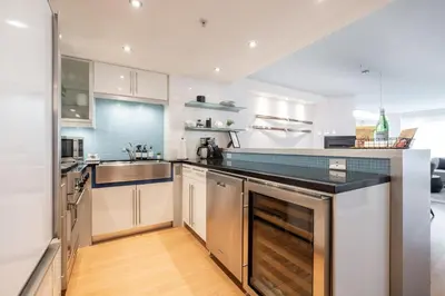 a kitchen with white cabinets and a counter top at Woodrun by Outpost Whistler in Whistler