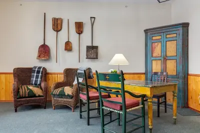 a dining room with a wooden table and chairs at Courthouse Inn Revelstoke in Revelstoke
