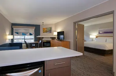 a hotel room with a bed and a large mirror at Holiday Inn Express Kamloops by IHG in Kamloops