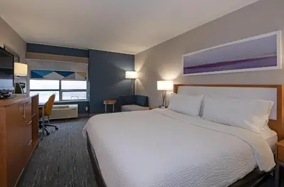 a hotel room with a large bed and a desk at Holiday Inn Express Kamloops by IHG in Kamloops