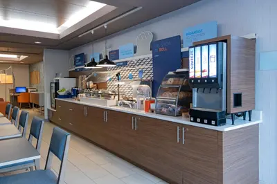a fast food restaurant with a counter and chairs at Holiday Inn Express Kamloops by IHG in Kamloops