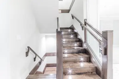 a staircase in a house with wooden stairs and metal railings at Kim's Place in Surrey