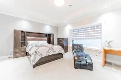 a bedroom with a bed and a desk at Kim's Place in Surrey