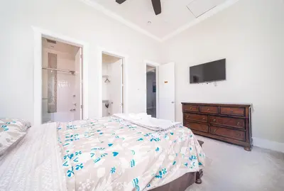 a bedroom with a bed and a dresser and a tv at Kim's Place in Surrey