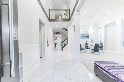 an office lobby with white marble floors and a ceiling at Kim's Place in Surrey